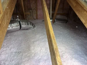 An attic with insulation and ductwork